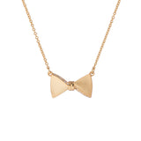 tessla: crystal tux bow gold pendant